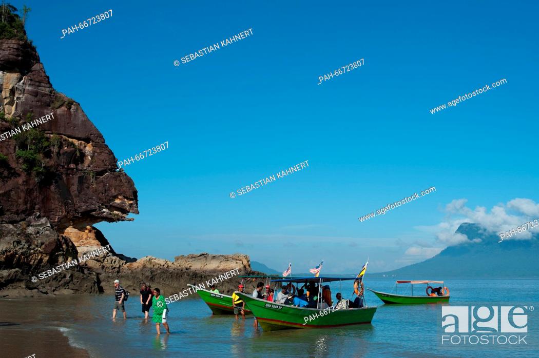 Stock Photo: Tourists are departing a boat on the shore of the South China Sea at the Bako National Park near Kuching, Malaysia, 25 October 2014.