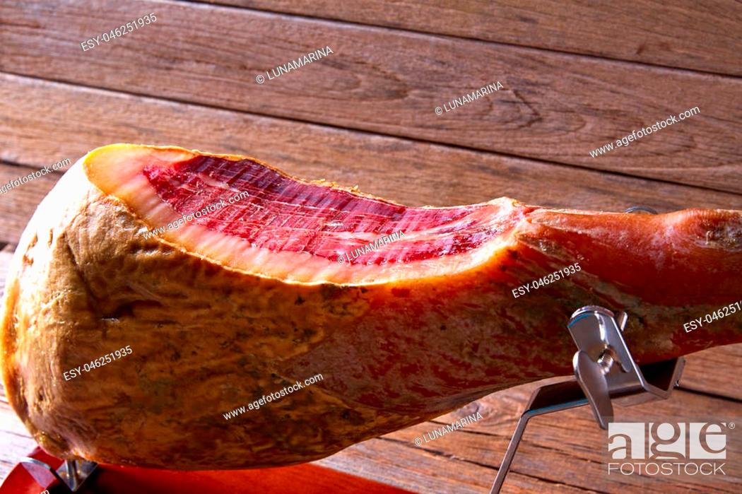 Stock Photo: Iberian ham pata negra from Spain cut by hand on wood.