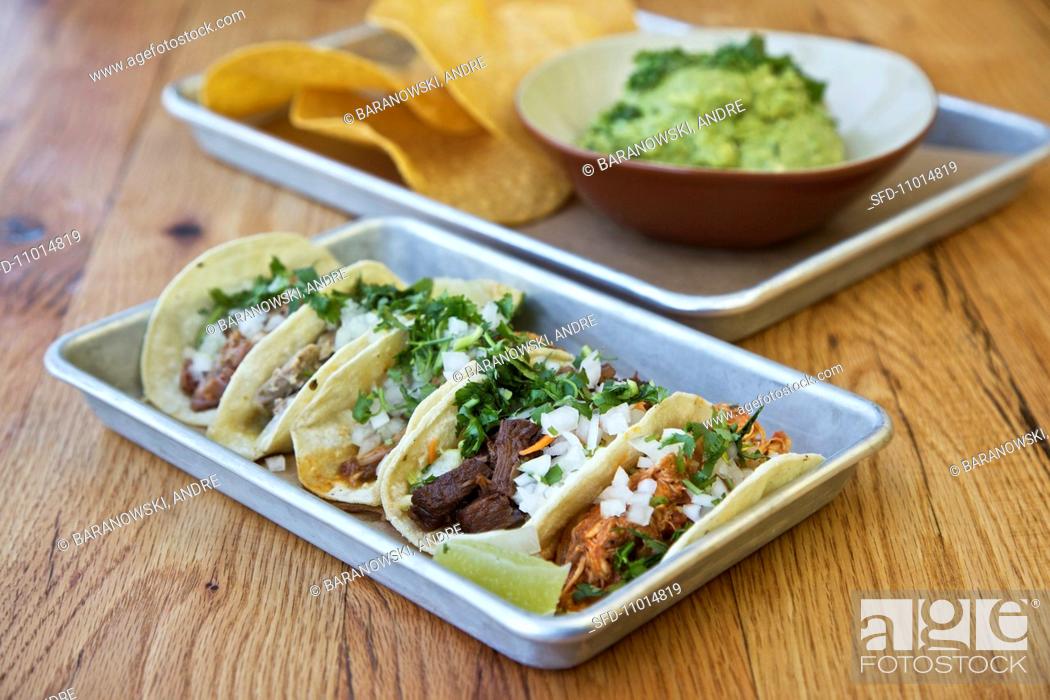 Stock Photo: Various tacos with guacamole and tortilla chips (Mexico).