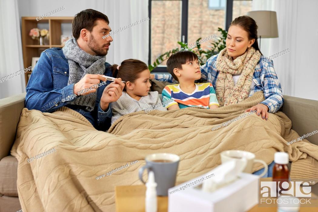 Stock Photo: family with ill children having fever at home.