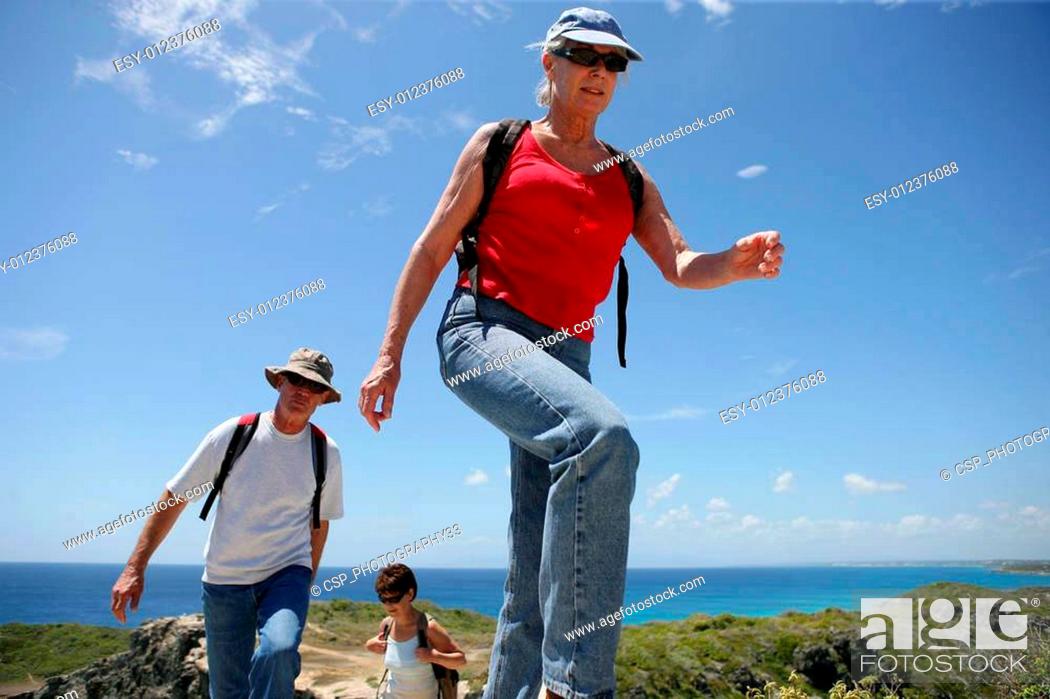 Stock Photo: Group of senior persons hiking by a sunny day.