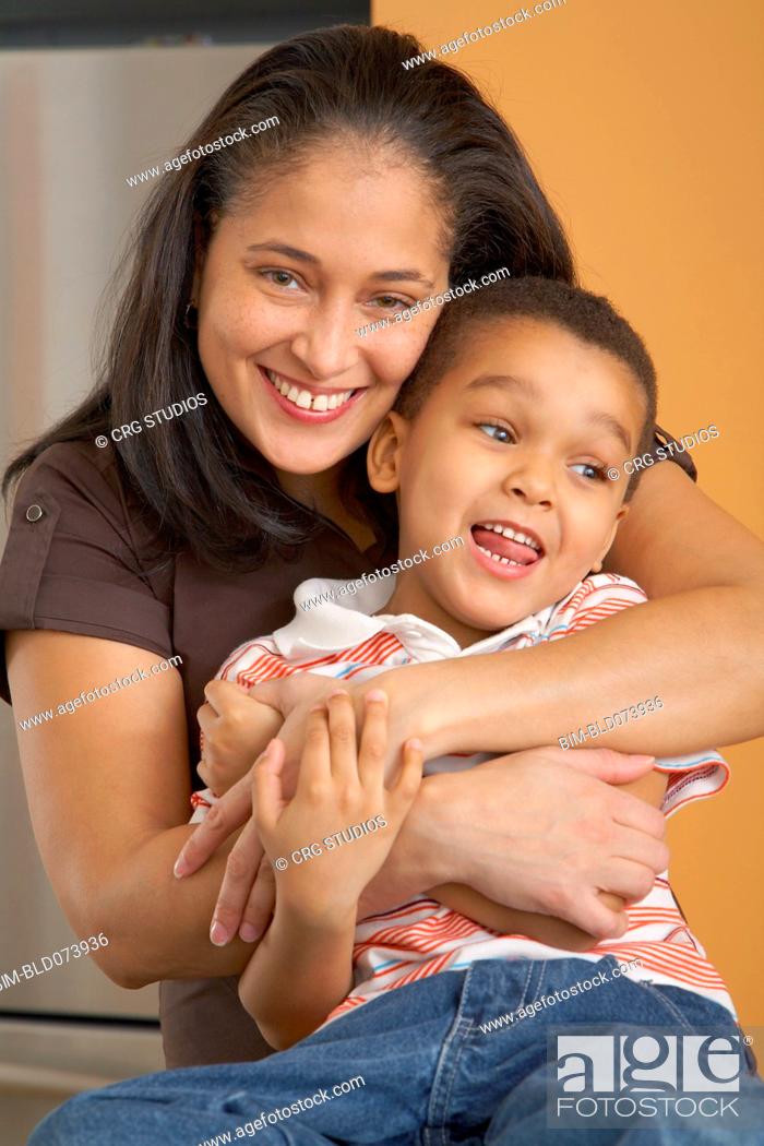 Stock Photo: Dominican mother hugging son.
