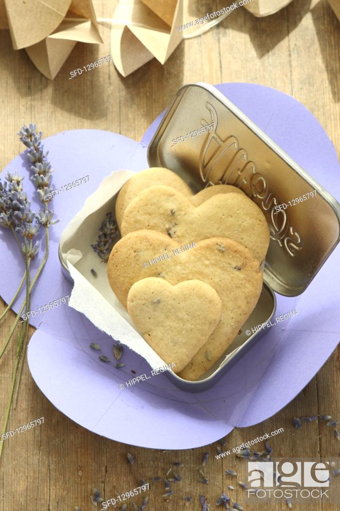 Stock Photo: Heart-shaped, gluten-free lavender shortbread biscuits in a biscuit tin.