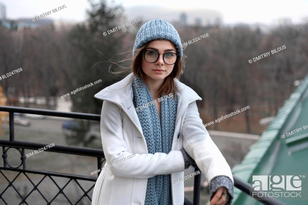 Stock Photo: Wind blowing hair of Caucasian woman wearing hat and scarf.
