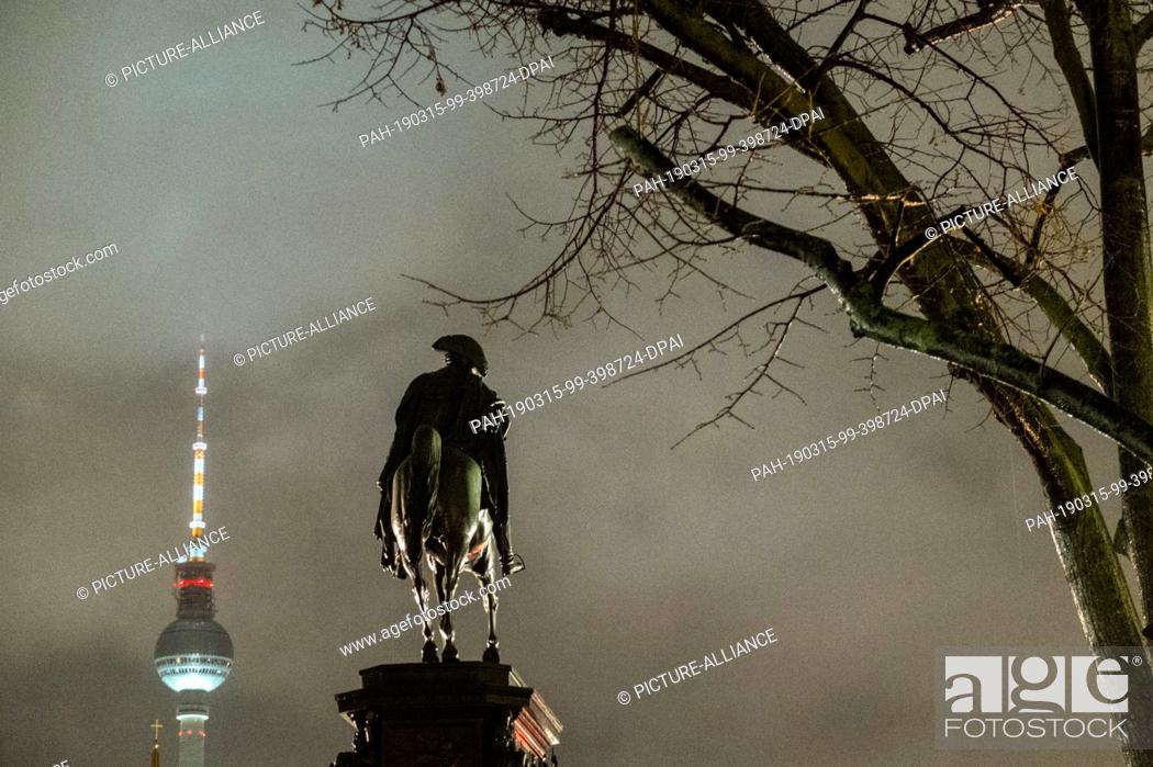 Stock Photo: 12 January 2019, Berlin: A statue of the Prussian king Frederick the Great, popularly called the ""Old Fritz"", stands in the drizzle on the magnificent avenue.