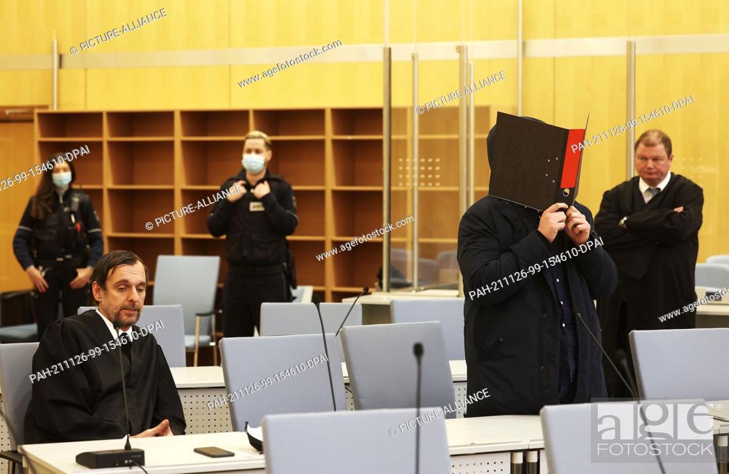 Stock Photo: 26 November 2021, North Rhine-Westphalia, Duesseldorf: The accused IS terrorist Nils D. (2nd from right) stands between his lawyers Jan-Henrik Heinz (r) and.