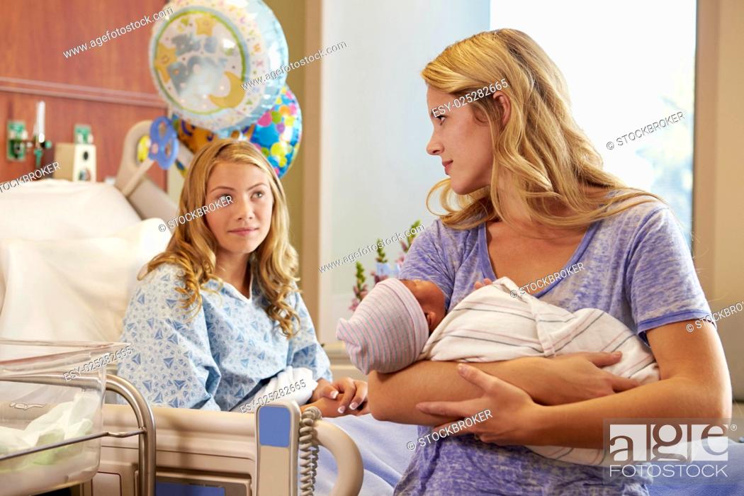 Stock Photo: Mother Holding Teenage Daughter's Newborn Baby In Hospital.