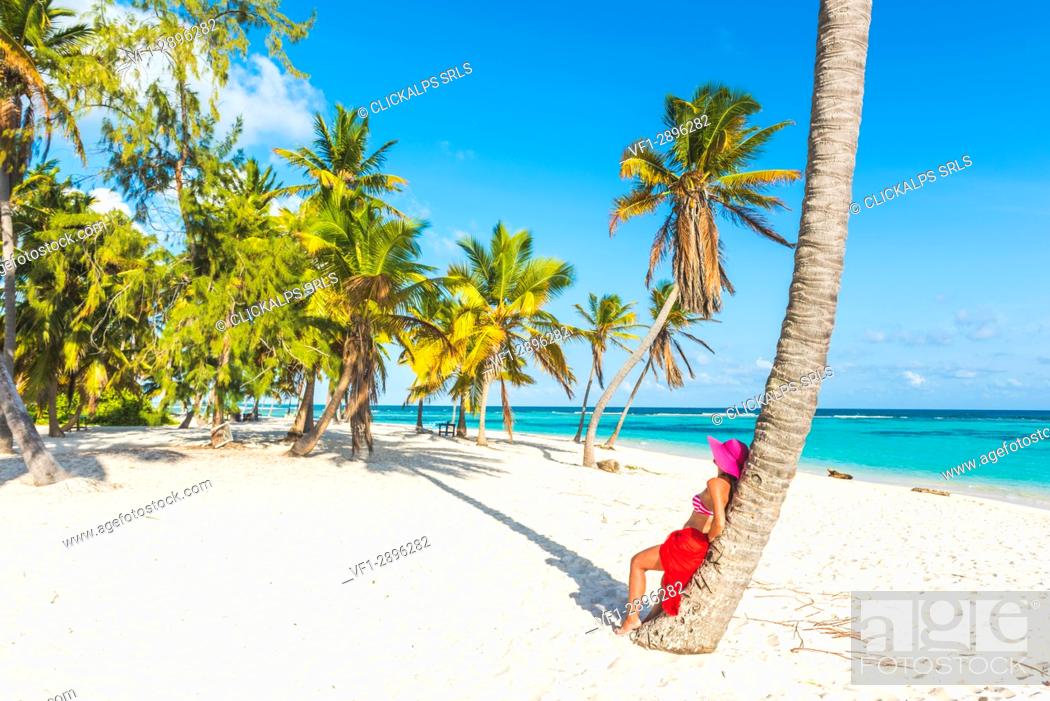 Stock Photo: Canto de la Playa, Saona Island, East National Park (Parque Nacional del Este), Dominican Republic, Caribbean Sea. Beautiful woman with red sarong relaxing on.
