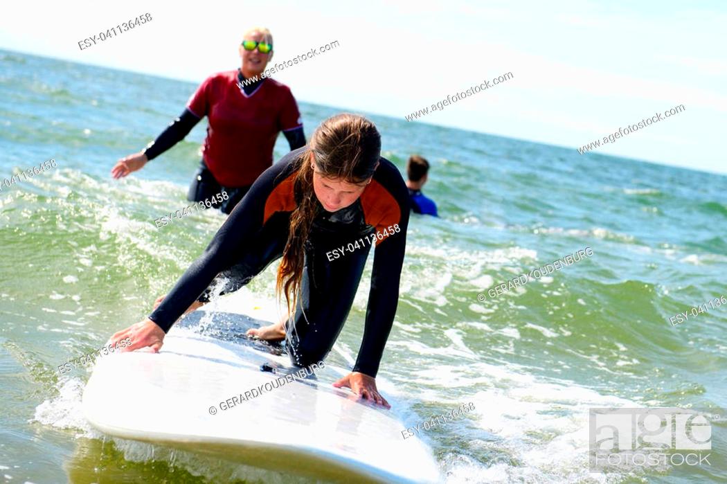 Stock Photo: Beach vacation. Happy young girl on surfboard.