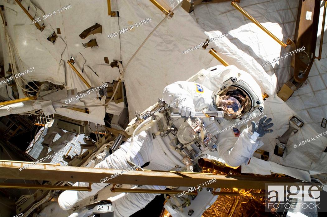 Stock Photo: NASA astronaut Alvin Drew, STS-133 mission specialist, participates in the mission's first session of extravehicular activity (EVA) as construction and.