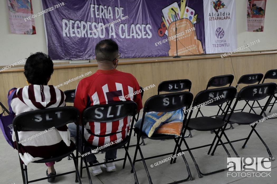 Stock Photo: August 20, 2022, Mexico City, Mexico: Parents attend at the school supplies fair  at the Utopia Tezontli, to looked for school supplies for their children for.