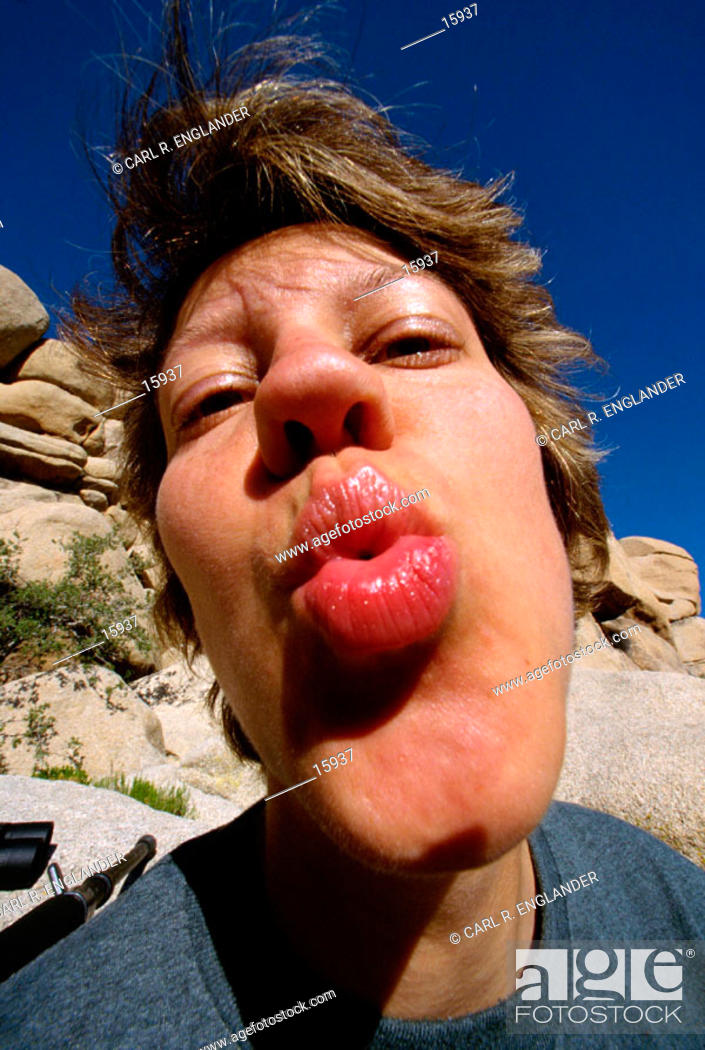 Stock Photo: Woman puckering lips and kissing.