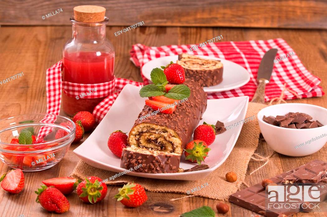Stock Photo: Chocolate roll with hazelnuts and strawberries.