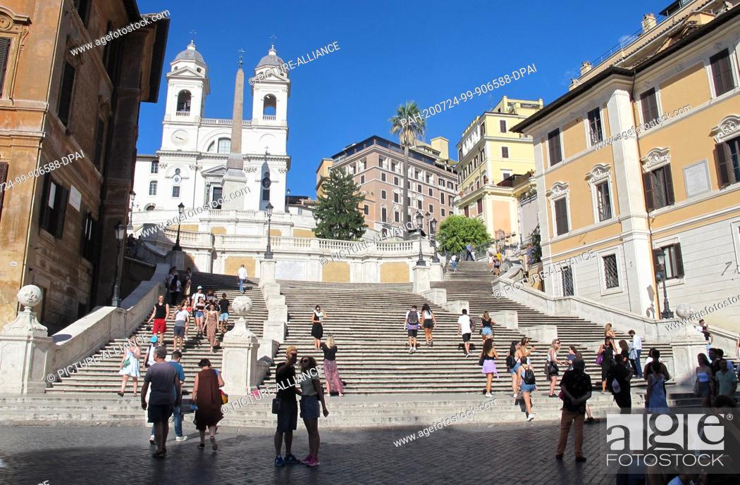 Stock Photo: 18 July 2020, Italy, Rom: Few people stand at the Spanish Steps in Rome. The number of foreign tourists in Italy's capital is extremely low due to the Corona.