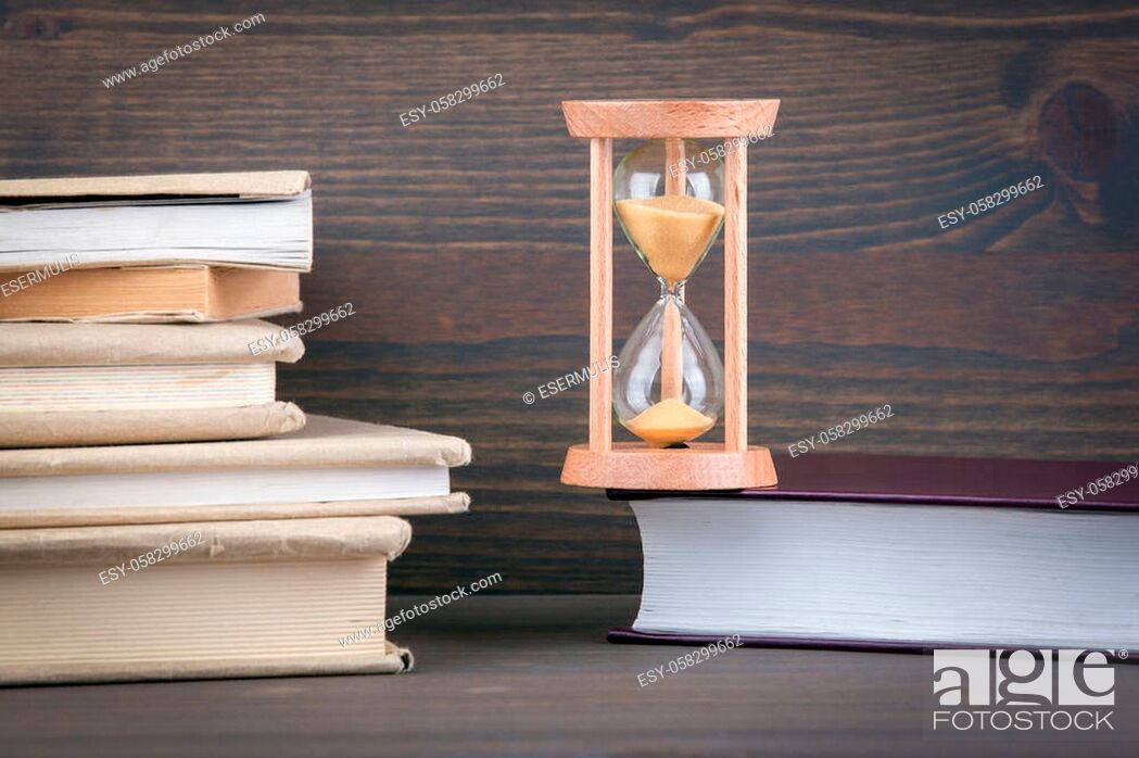 Stock Photo: Sandglass, hourglass or egg timer on wooden table showing the last second or last minute or time out.