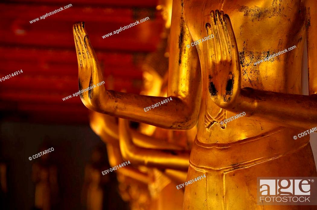 Stock Photo: Goleden statue with asian style, with a background more Budhha statue.