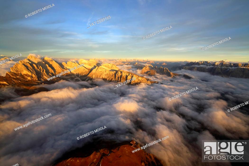 Stock Photo: Aerial shot from Seceda of Odle surrounded by clouds at sunset. Dolomites Val Funes Trentino Alto Adige South Tyrol Italy Europe.