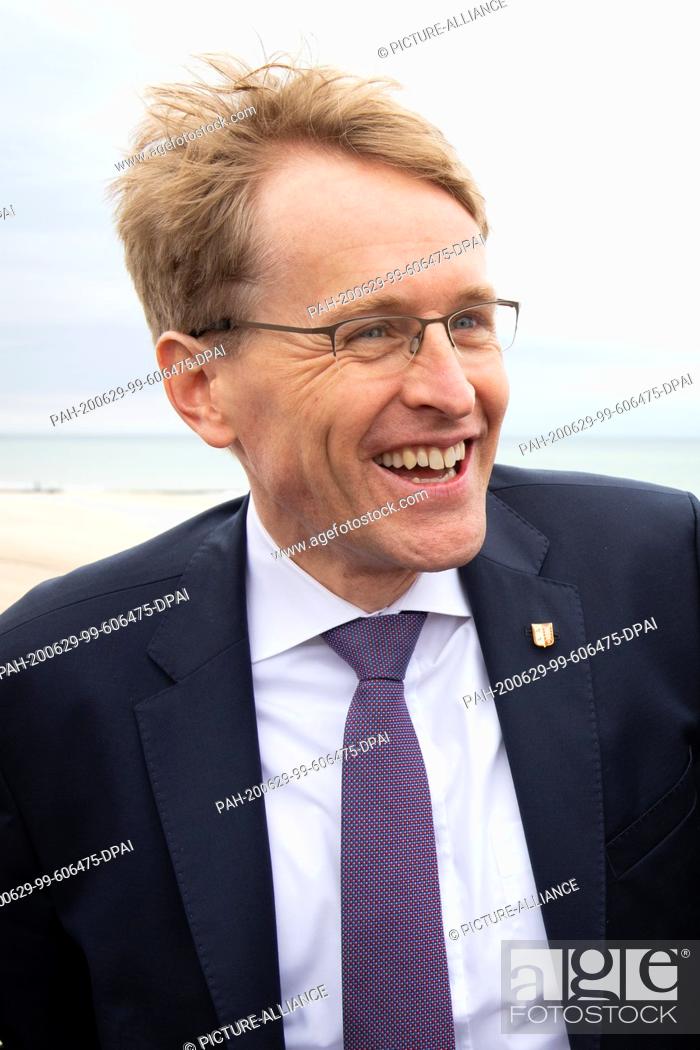 Stock Photo: 11 June 2020, Schleswig-Holstein, Westerland/Sylt: Prime Minister Daniel Günther (CDU) laughs while visiting the beach promenade in Westerland on Sylt.