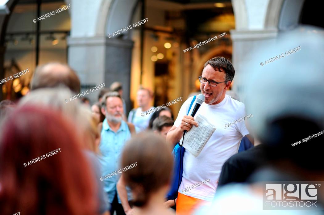 Stock Photo: The London-born and Vienna-based city guide, Eugene Quinn, speaks to the around 100 participants in front of a building on Kaufinger-Strasse during the first.