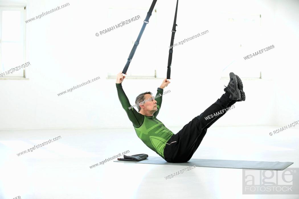 Stock Photo: Man doing his fitness regime, doing suspension training.