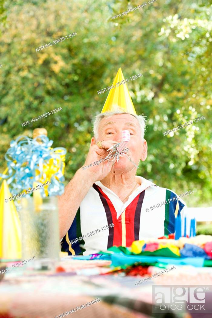 Stock Photo: Senior man at a birthday party.