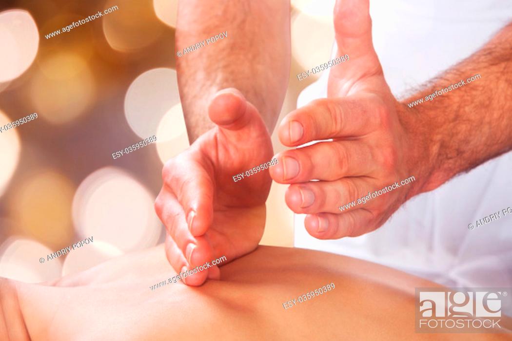 Stock Photo: Closeup of male therapist massaging female customer's back at beauty spa.