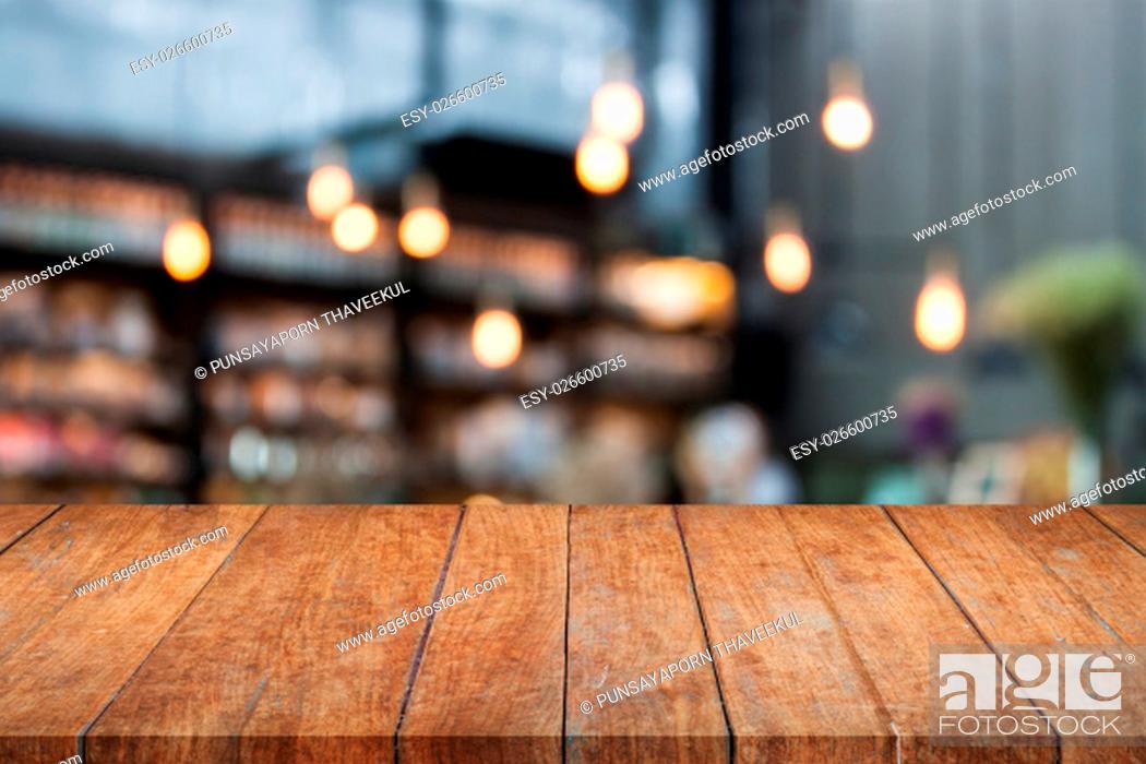 Stock Photo: Perspective table top wooden with blurred cafe background. product display template.