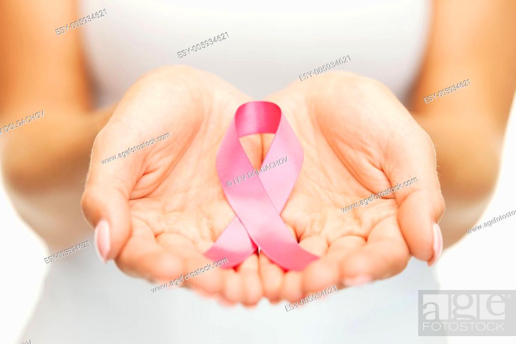 Stock Photo: healthcare and medicine concept - womans hands holding pink breast cancer awareness ribbon.
