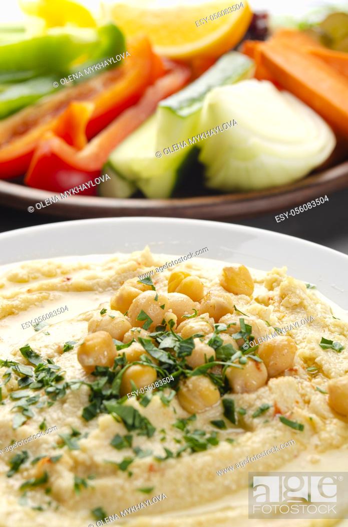 Stock Photo: Low angle view at vegetable Hummus dip dish topped with chickpeas and olive oil.