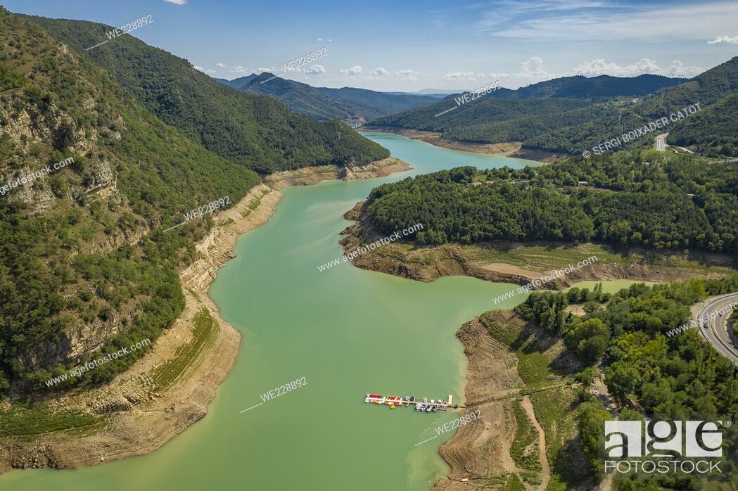 Stock Photo: Aerial view of the Baells reservoir with a very low level (36%) during the summer drought of 2022 (Berguedá , Barcelona, Catalonia, Spain).
