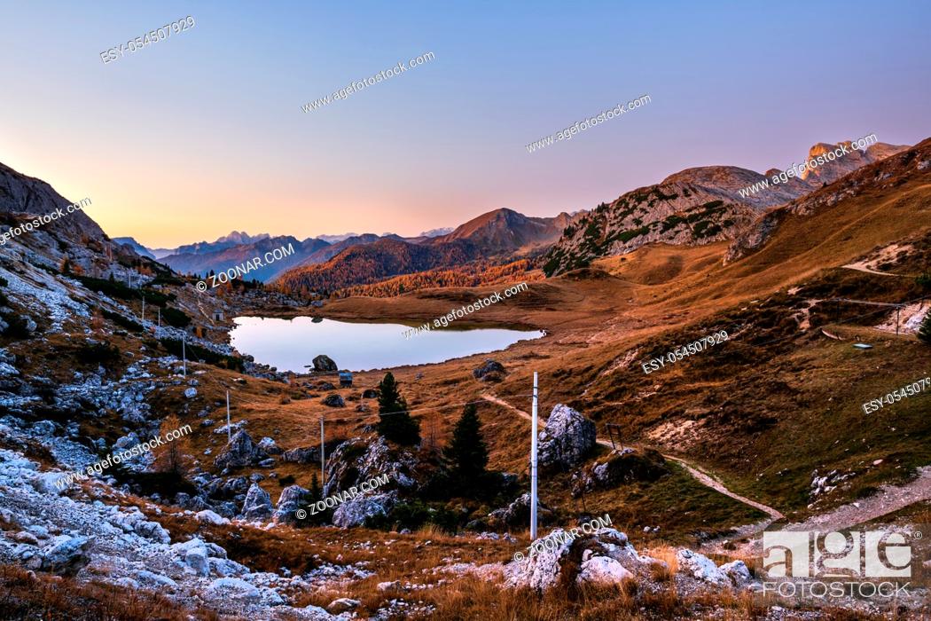 Stock Photo: Early morning autumn alpine Dolomites mountain scene. Peaceful Valparola Path and Lake view, Belluno, Italy.  Picturesque traveling, seasonal.