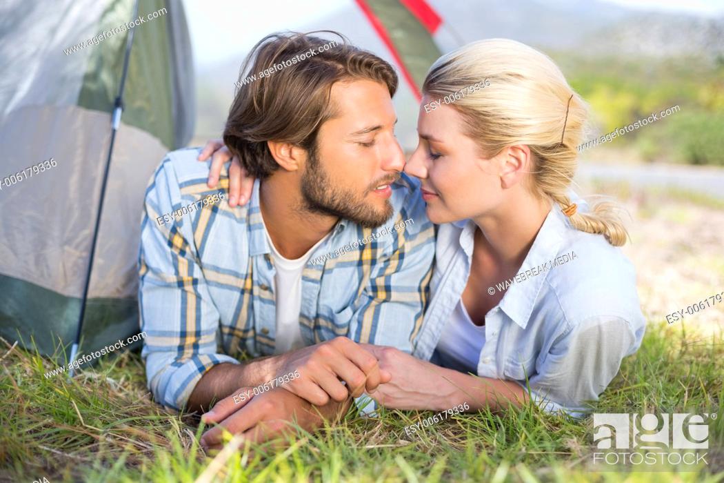 Stock Photo: Attractive couple lying in their tent about to kiss.