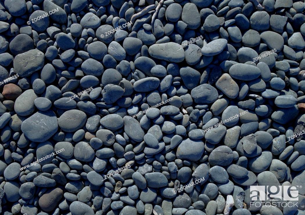 Stock Photo: pebbles on a beach background texture wallpaper.