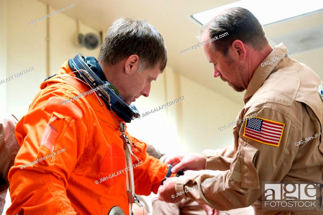 Stock Photo: NASA astronaut Chris Ferguson, STS-135 commander, dons a training version of his shuttle launch and entry suit in preparation for a training session in the.