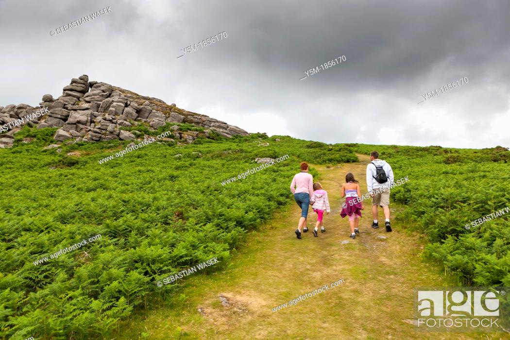 Stock Photo: Family walking up Bell Tor in the Dartmoor National Park, near Widecombe in the Moor, Devon, England, UK, Europe.