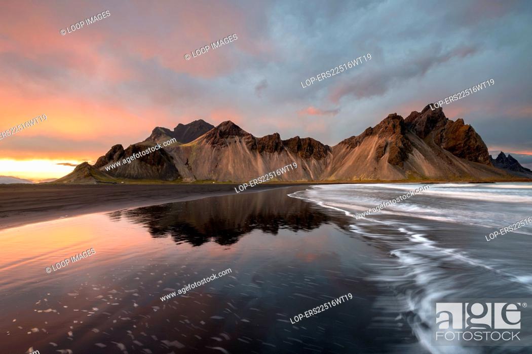 Stock Photo: The Vestrahorn mountain reflected at sunset.