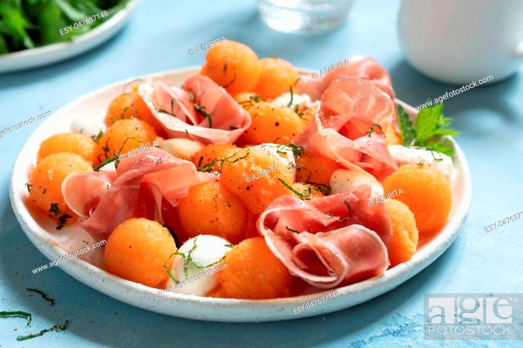 Stock Photo: Cantaloupe melon salad with mozzarella and prosciutto ham.