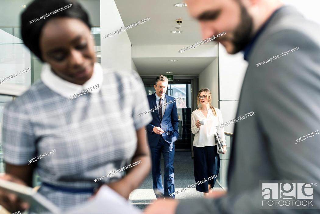 Stock Photo: Business people talking on office floor.