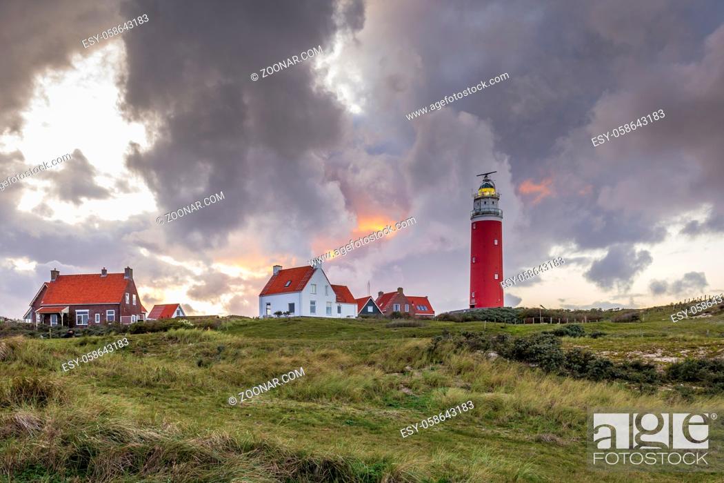Stock Photo: Landscape with scenic view of Lighthouse during sunset with rainy clouds at Waddenisland Texel, North Holland, Netherlands.