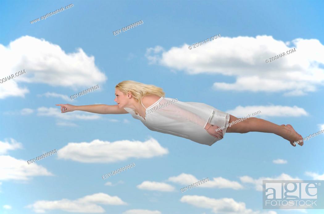 Stock Photo: Beautiful young woman flying or falling through the air.