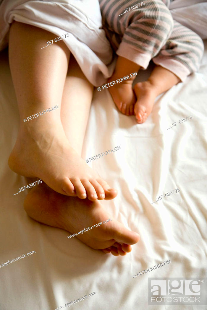 Stock Photo: Mother and baby daughter sleeping in bed in hotel.