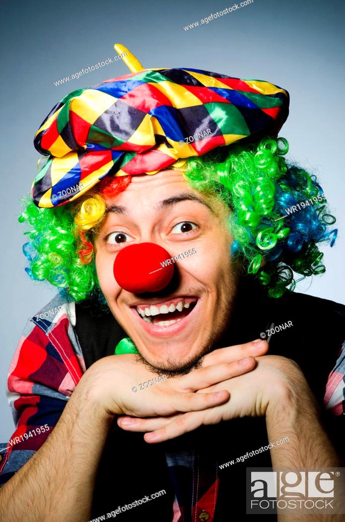 Stock Photo: Funny clown against the dark background.