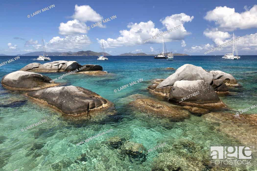 Stock Photo: Boulders dot the waters of the Baths with boats moored in the distance at the Baths on Virgin Gorda in the British Virgin Islands.