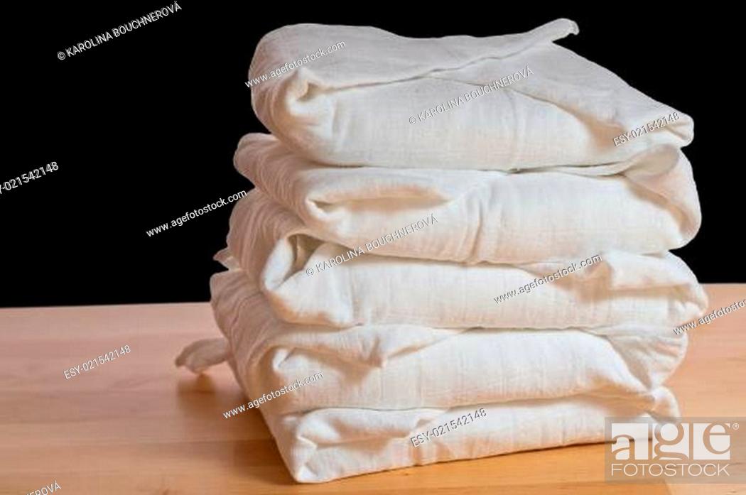 Stock Photo: Stack of classical square white cloth diapers.