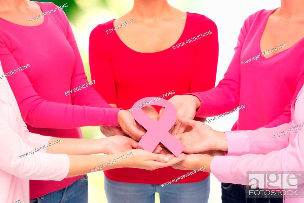 Stock Photo: healthcare, people and medicine concept - close up of women in blank shirts with pink breast cancer awareness ribbon over green background.