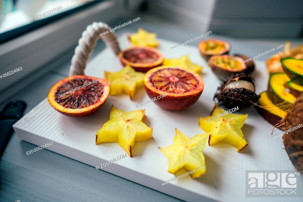 Stock Photo: Exotic fruits on a tray on a light background.