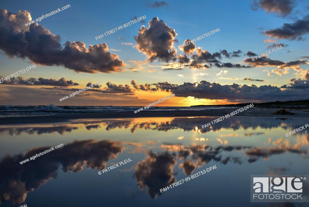 Stock Photo: The sunset seen from the Danish island Bornholm at the Baltic Sea near Dueodde, Denmark, 21 August 2017. The island of Bornholm and the island group Ertholmene.