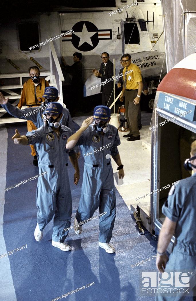 Stock Photo: USS Hornet crewmen are greeted by the crew of the Apollo 12 lunar landing mission as the three astronauts are transferred from a U.S.