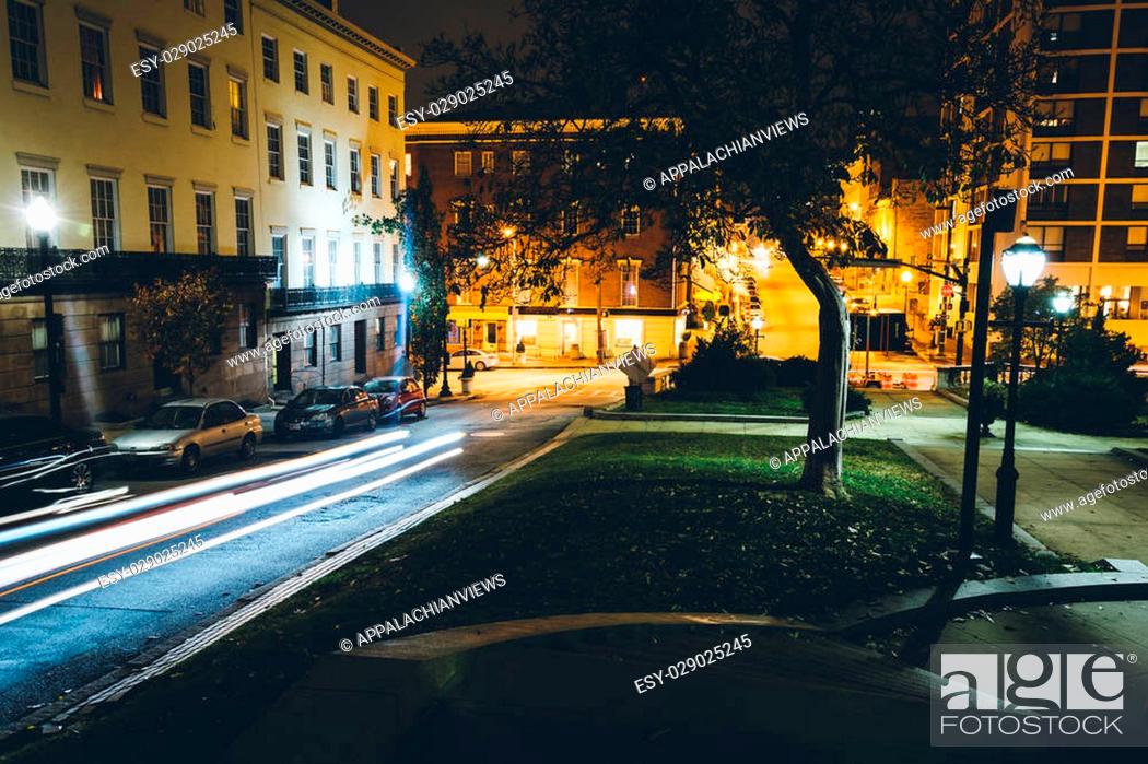Stock Photo: Traffic and historic buildings on Charles Street at night in Mount Vernon, Baltimore, Maryland.