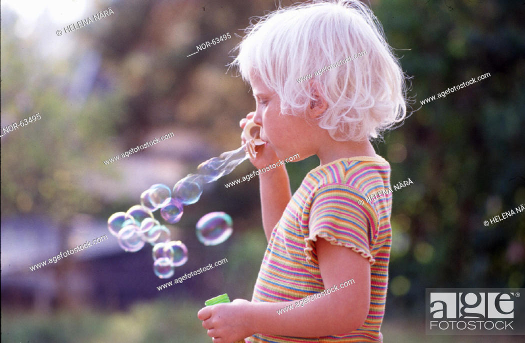 A Child Blowing Bubbles Stock Photo Picture And Rights Managed